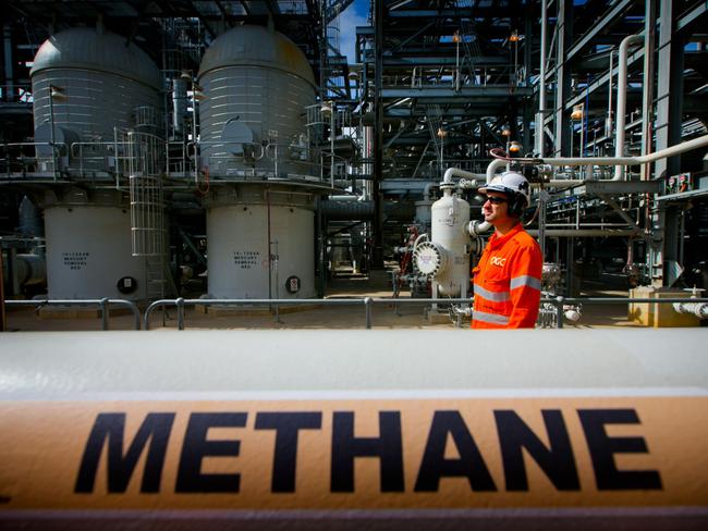 A worker walks past a gas pipe marked "Methane" at the Curtis Island liquefied natural gas (LNG) plant, a part of the Queensland Curtis Liquefied Natural Gas (QCLNG) project site operated by QGC Pty, a unit of Royal Dutch Shell Plc, in Gladstone, Australia, on Wednesday, June 15, 2016. Gas from more than 2,500 wells travels hundreds of miles by pipeline to the project, where it's chilled and pumped into 10-story-high tanks before being loaded onto massive ships. Photographer: Patrick Hamilton/Bloomberg