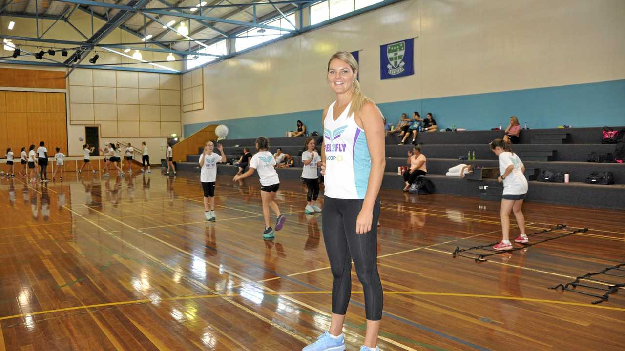 Queensland Firebirds player Gretel Tippett puts some netballers through their paces during a drill at the Fuel2Fly netball clinic. Picture: Alyssa Welke