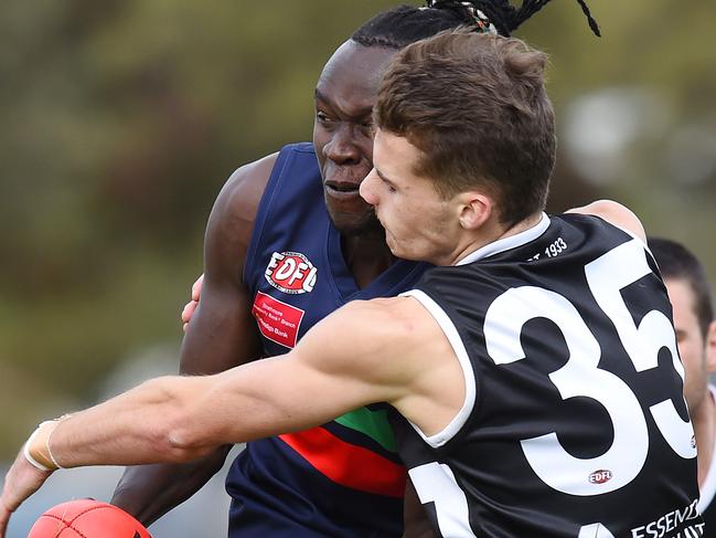 Northern Saints’ Samuel Malual and Moonee Valley's Samuel Milne fight for possession. Picture: Josie Hayden