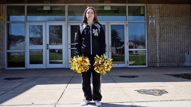 Brandi Levy in her former cheerleading outfit outside Mahanoy Area High School.