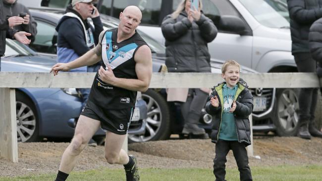 Former AFL star Barry Hall kicks his third goal for Cygnet and young fan Oliver Meers, 10, celebrates in the background. Picture: PATRICK GEE