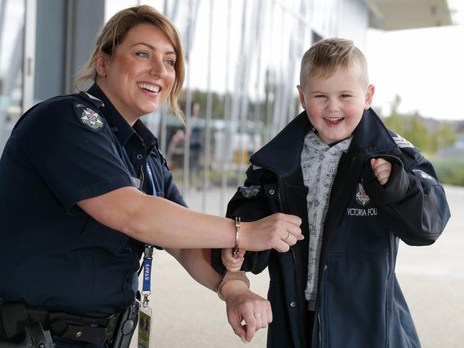 Acting Sergeant Rebecca Amiridis gets ‘locked up’ by Ari, 4, outside Splash in Craigieburn. Picture: George Salpigtidis