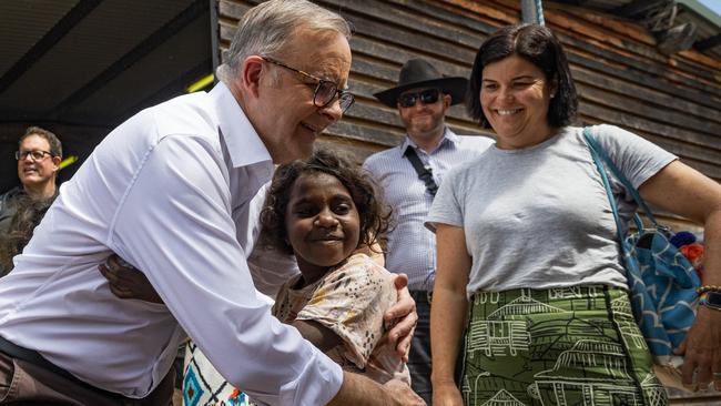 Prime Minister Anthony Albanese embraces a young Yolngu child during Garma Festival 2022. Picture: Tamati Smith/Getty Images