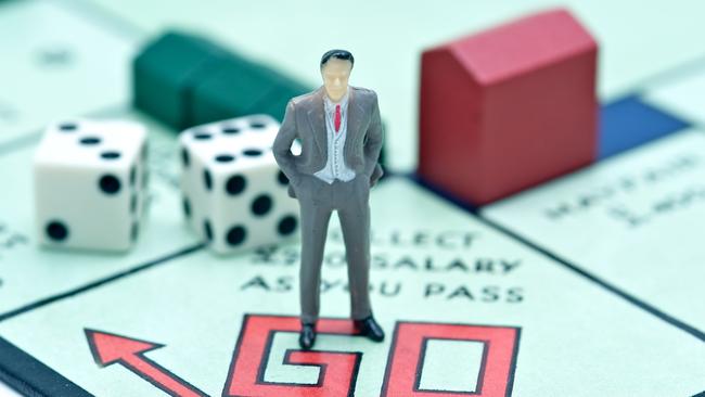 London, UK - July 2, 2011: Model figurine of a businessman at the starting point of the board game monopoly