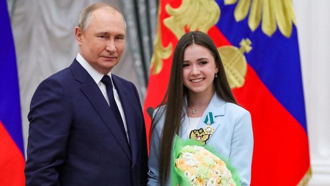 Russian President Vladimir Putin poses with figure skater Kamila Valieva, who was later stripped of her gold medal from the Beijing 2022 Winter Olympics. (Photo by Mikhail KLIMENTYEV / SPUTNIK / AFP)