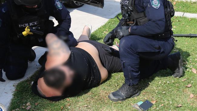 25-year-old Danny Watfa is placed in handcuffs at a home on Abel Street in Greenacre, Thursday, October 15, 2020. Picture: NSW Police Media