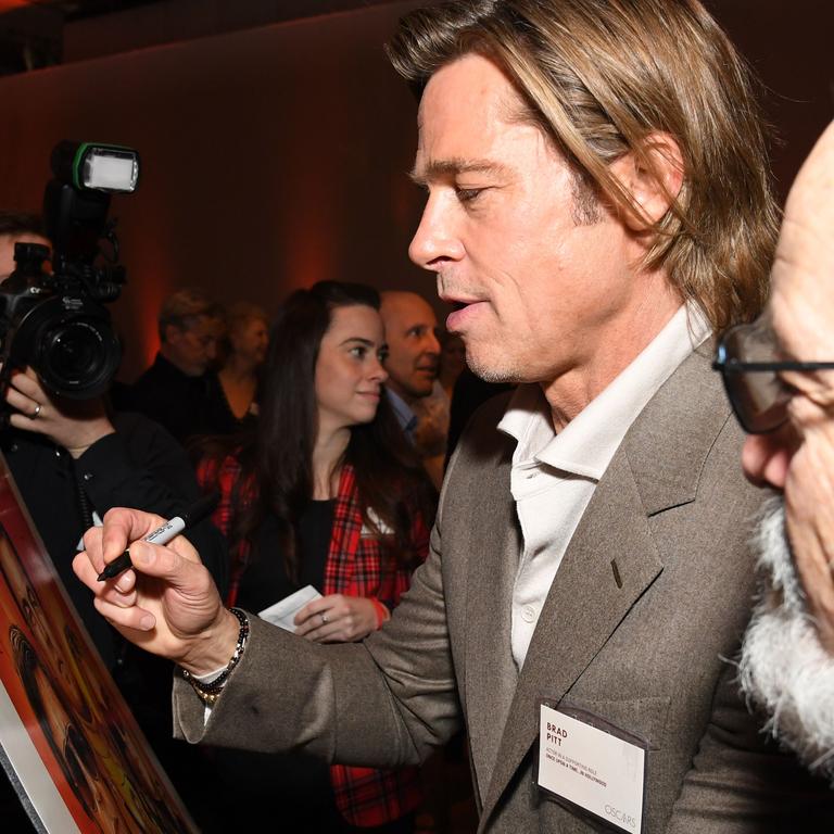 Pitt signs autographs. Picture: Robyn Beck / AFP