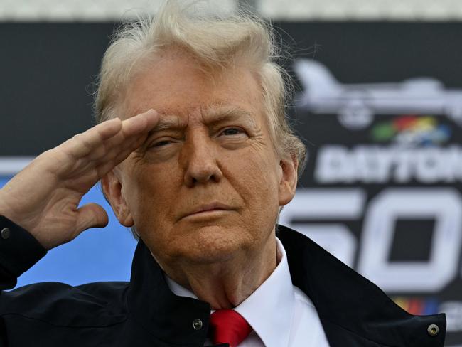 President Donald Trump salutes as he attends the NASCAR Daytona 500 auto race at Daytona International Speedway, Sunday, Feb. 16, 2025, in Daytona Beach, Fla. (Pool via AP)