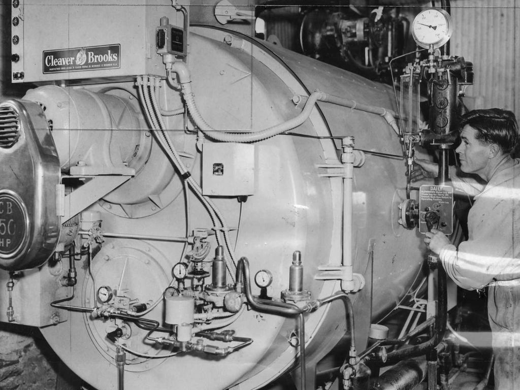 Inside the Amscol icecream factory, where a worker checks the boiler.