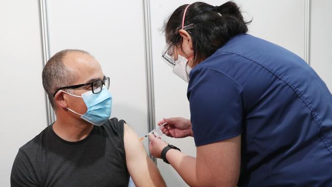 Acting Premier James Merlino receiving his booster shot at the Royal Exhibition Building on Thursday. Picture: David Crosling