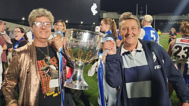 Leesa Catto (left) and Sal Rees (right) holding the 2024 AFLW Premiership Cup at Ikon Park.