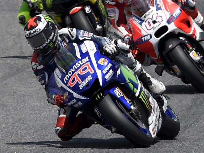 Movistar Yamaha MotoGP's Spanish rider Jorge Lorenzo leads after the start of the Catalunya Grand Prix at the Barcelona-Catalunya racetrack in Montmelo, near Barcelona on June 14, 2015. AFP PHOTO / LLUIS GENE