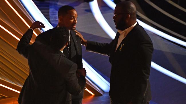 Smith was comforted by Tyler Perry and Denzel Washington. Picture: The Hollywood Reporter. Picture: Robyn Beck/AFP