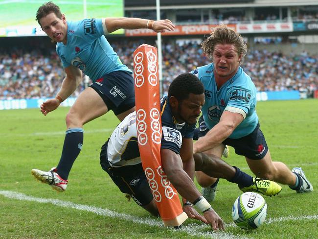 Michael Hooper of the Waratahs tackles Henry Speight of the Brumbies.