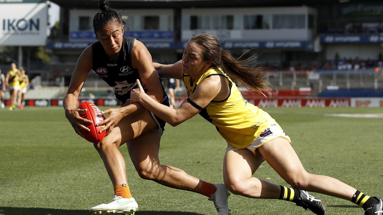 Darcy Vescio is tackled by Burchell during their AFLW Round 4 at Ikon Park in February.