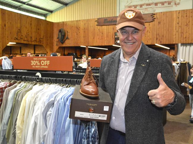 R.M Williams die hard Wayne Preedy with a pair of men's brown leather boots at the Toowoomba outlet sale on May 8, 2025. Photo: Jessica Klein
