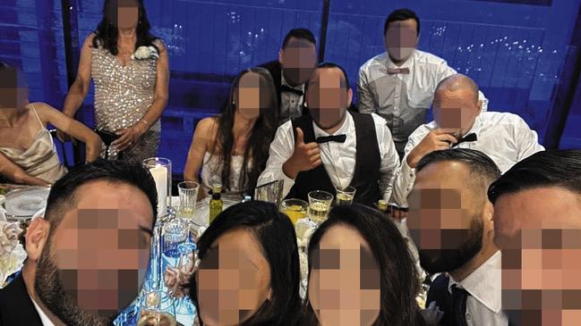 Guests celebrate with the bride and groom at a Pyrmont wedding that saw 21 people fined for breaching lockdown restrictions.