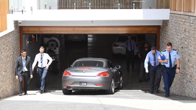 Former Auburn deputy mayor Salim Mehajer reverses his BMW Z4 out of the underground carpark at his home as New South Wales Police continue to raid his home in Lidcombe, Sydney. Picture: AAP Image/Dean Lewins.