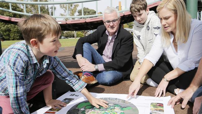 Senator Andrew Wilkie and Glenorchy Mayor Kristie Johnston look over the plans for a significant new playground to be built in Goodwood, with Tom Vagg, 7, left, and Harry Johnston, 12. Picture: MATHEW FARRELL