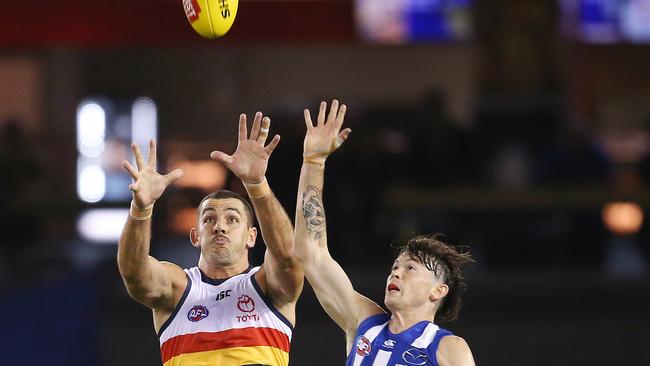 Crows co-captain Taylor Walker goes up for a mark against Jasper Pittard of the Kangaroos. Picture: Michael Klein.