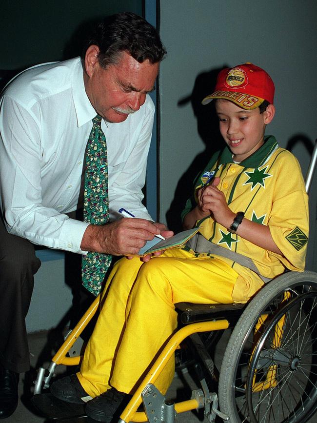 Barassi signs for a 12-year-old in 1996