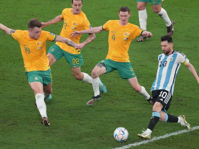 DOHA, QATAR - DECEMBER 03: Lionel Messi of Argentina in action under pressure from Harry Souttar, Jackson Irvine and Kye Rowles of Australia during the FIFA World Cup Qatar 2022 Round of 16 match between Argentina and Australia at Ahmad Bin Ali Stadium on December 03, 2022 in Doha, Qatar. (Photo by Etsuo Hara/Getty Images)