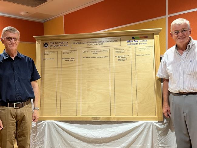 Medical Honour Board 1 (left to right) Former Hervey Bay Hospital clinician Dr Henk Van Rooyen and  Hervey Bay Woodcrafts Club  president Russell McCaliece reveal the Medical Honour Board.