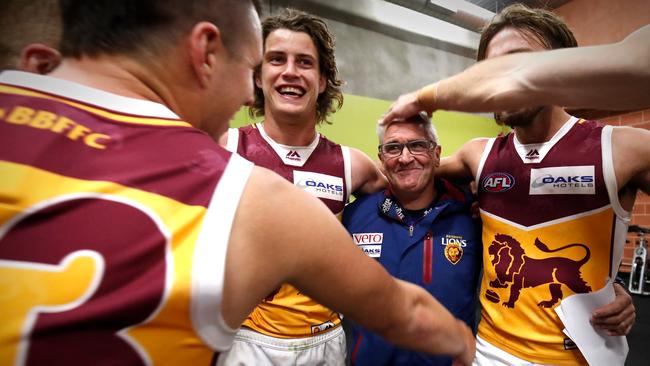 Brisbane players celebrate with coach Chris Fagan after beating the Hawks in Launceston. Picture: Getty Images