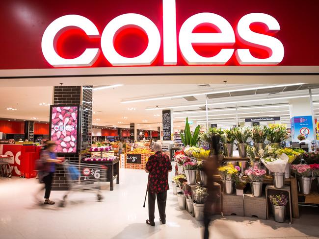 A shopper stands at the entrance to a Coles supermarket, operated by Wesfarmers Ltd., in Sydney, Australia, on Tuesday, Feb. 18, 2014. Wesfarmers, Australia's largest employer, is scheduled to report first-half earnings on Feb. 19. Photographer: Ian Waldie/Bloomberg via Getty Images