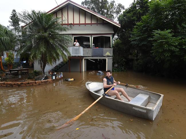 Lennon Bartlett rows a boat to his parents house next door to where he lives in central Lismore, New South Wales, Friday, March 31, 2017. The Wilsons River breached its banks early morning flooding the far-northern NSW town. (AAP Image/Dave Hunt) NO ARCHIVING