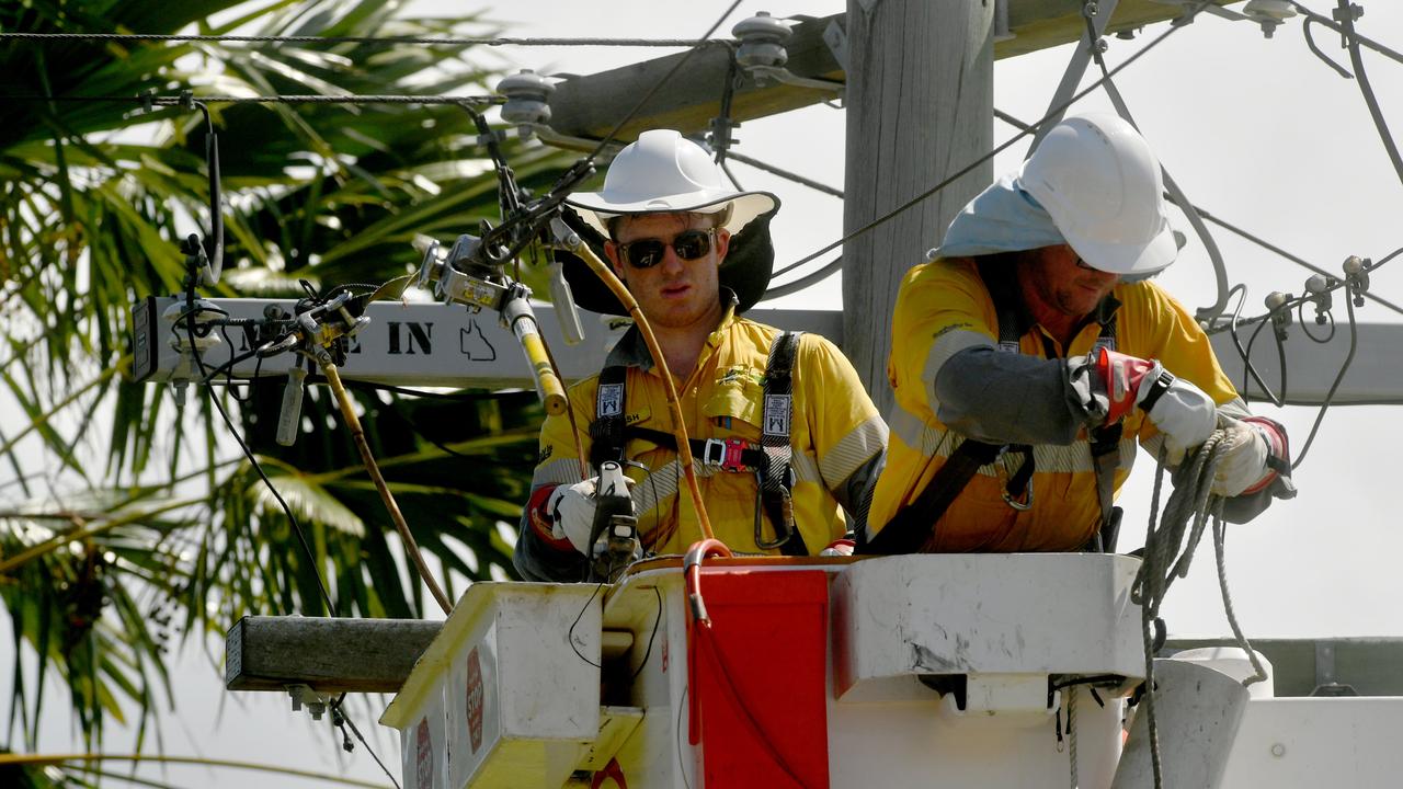 Ergon Energy workers restore power in Flower Street, Railway Estate, Townsville over the weekend. About 4,500 North Queenslanders remained without power on Monday morning as a heatwave continues to bake the region. Picture: Evan Morgan