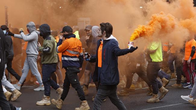 Protesters set off flares as they rallied in the CBD. Picture: Alex Coppel