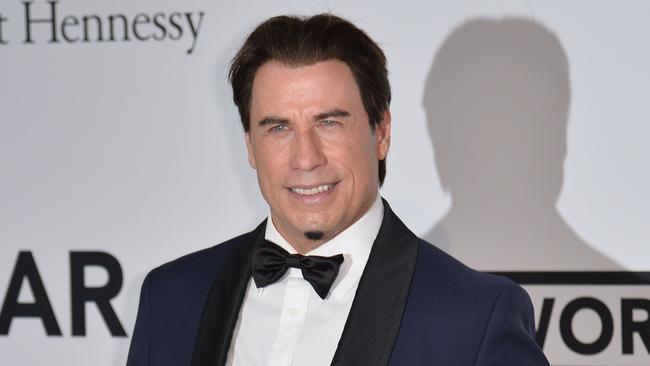 US actor John Travolta poses as he arrives for the amfAR 21st Annual Cinema Against AIDS during the 67th Cannes Film Festival at Hotel du Cap-Eden-Roc in Cap d'Antibes, southern France, on May 22, 2014. AFP PHOTO / ALBERTO PIZZOLI