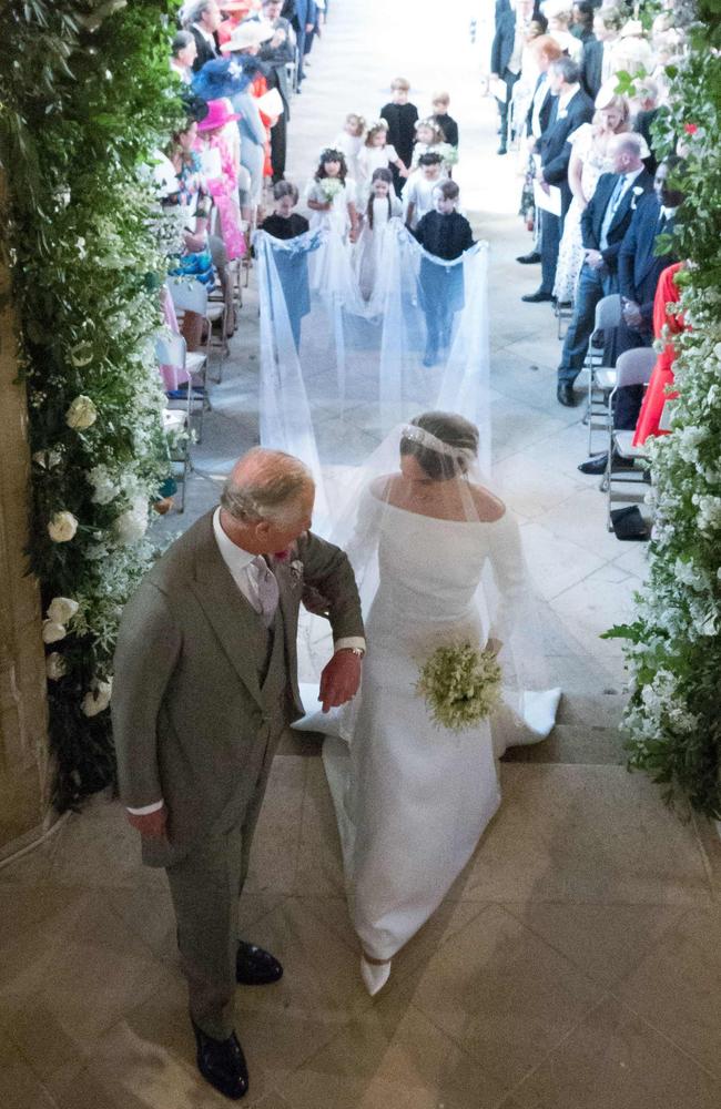 Meghan Markle takes the arm of Prince Charles as she walks down the aisle. Picture: Dominic Lipinski