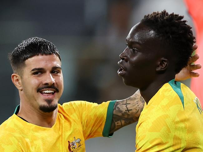 SYDNEY, AUSTRALIA - MARCH 24: Garang Kuol (r) of the Socceroos celebrates with Marco Tilio of the Socceroos after scoring a goal during the International Friendly match between the Australia Socceroos and Ecuador at CommBank Stadium on March 24, 2023 in Sydney, Australia. (Photo by Mark Kolbe/Getty Images)