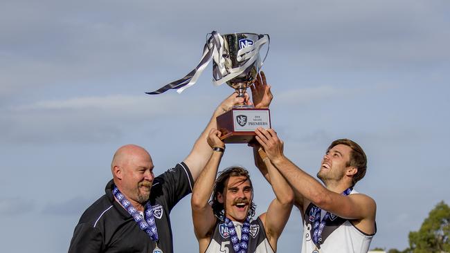 Southport Sharks coach Stephen Daniel celebrates the 2018 flag with captains Andrew Boston and Seb Tape Picture: Jerad Williams