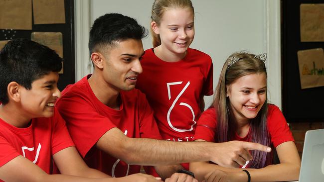 Taj Pabari (second left) with students Tanmay Pandya, Ziri Keen and Aurora Surawski at QUT this week. AAP/Jono Searle