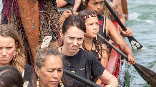 Jacinda Ardern (left) joins a Waka crew for a paddle prior to Waitangi Day in Waitangi. Picture: AAP.