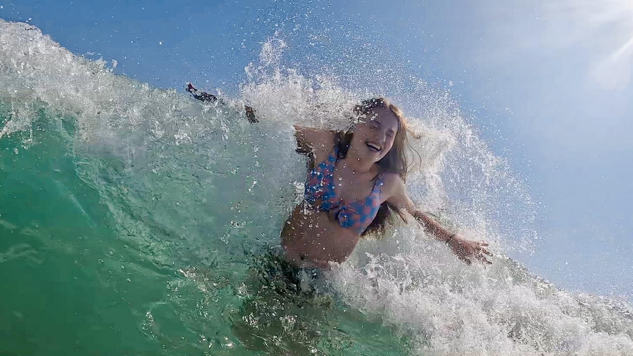 Smiles in the Surf is just one of the photos sent in by Herald Sun readers of their summer. Picture: Jacqui Garnsworthy