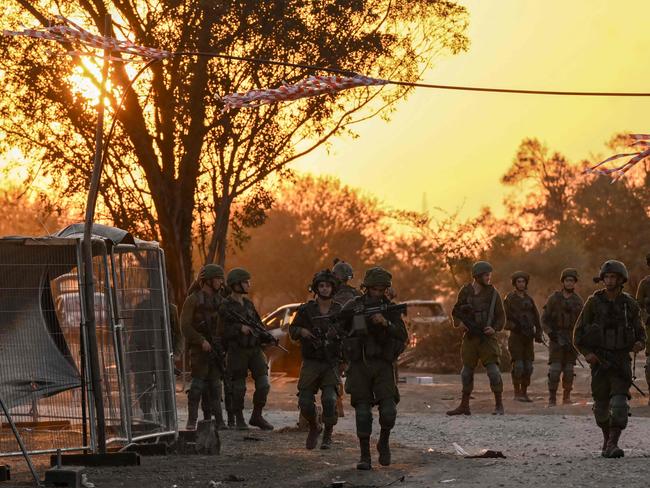 Israeli soldiers patrol on October 12, 2023 near Kibbutz Beeri, the place where 270 revellers were killed by Hamas militants during the Supernova music festivalon October 7. Thousands of people, both Israeli and Palestinians have died since October 7, 2023, after Palestinian Hamas militants entered Israel in a surprise attack leading Israel to declare war on Hamas in the Gaza Strip enclave the following day. (Photo by Aris MESSINIS / AFP)