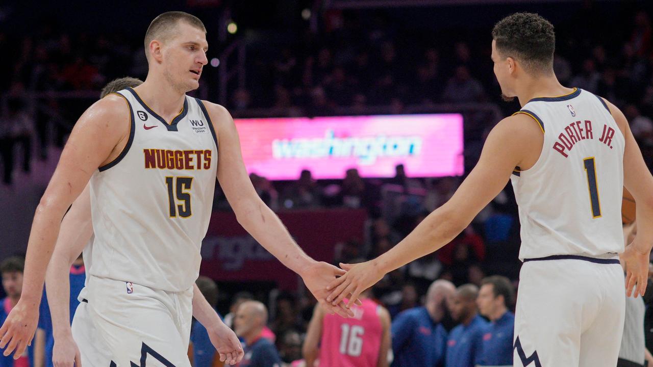 WASHINGTON, DC – MARCH 22: Nikola Jokic #15 and Michael Porter Jr. #1 of the Denver Nuggets slap hands during the second half against Washington Wizards at Capital One Arena on March 22, 2023 in Washington, DC. NOTE TO USER: User expressly acknowledges and agrees that, by downloading and or using this photograph, User is consenting to the terms and conditions of the Getty Images License Agreement. Jess Rapfogel/Getty Images/AFP (Photo by Jess Rapfogel / GETTY IMAGES NORTH AMERICA / Getty Images via AFP)