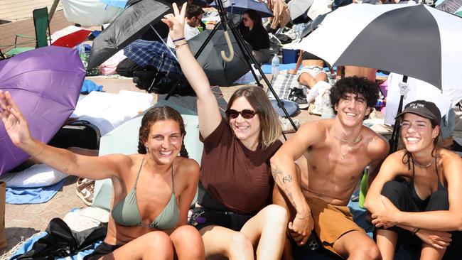 Ringing in the new year: friends, from left, Benedetta Zucchi, 25, Ilenia Pasquali, 23, Federico Monti, 23, and Gloria Galperti, 22, got up at 6am to get an early spot for the Sydney fireworks near the Opera House on Tuesday. Picture: Chris Pavlich