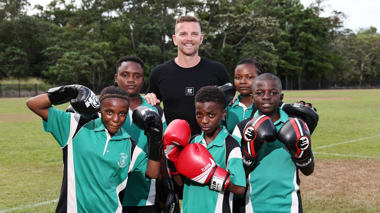 DF Gym had collaborated with Trinity Bay State High School to begin an after school Muay Thai program for students of diverse backgrounds. Patrick Doherty (centre) with Trinity Bay students Jane Pasccine, Tchishibanji Baguma, Juma Sadiki, Fazili Divinresse and Gloire Zagabe after a challenging fitness class. Picture: Brendan Radke