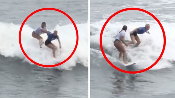 A rival surfer tries to push Aussie Willow Ryder off her board.