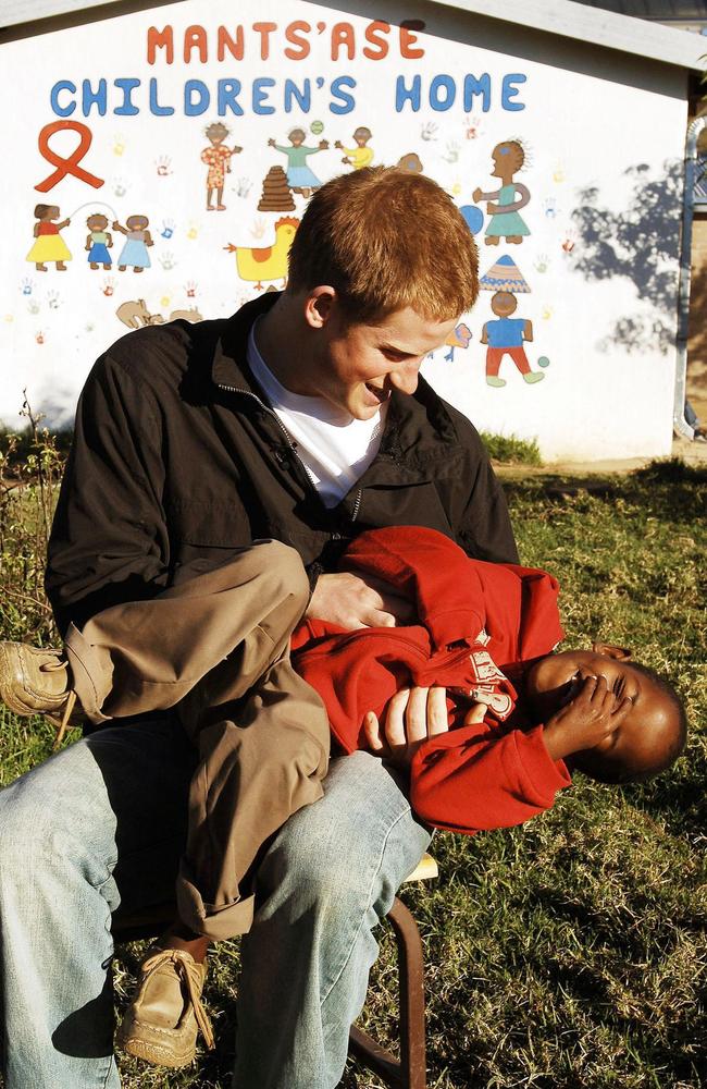 Harry plays with Mutsu in the grounds of the Mants'ase Children’s Home while on a return visit to Lesotho in Southern Africa in April 2006. Picture: AFP