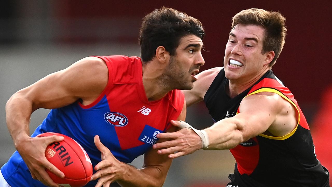 GOLD COAST, AUSTRALIA - SEPTEMBER 19: Christian Petracca of the Demons is tackled by Zach Merrett of the Bombers during the round 18 AFL match between the Essendon Bombers and the Melbourne Demons at Metricon Stadium on September 19, 2020 in Gold Coast, Australia. (Photo by Quinn Rooney/Getty Images)