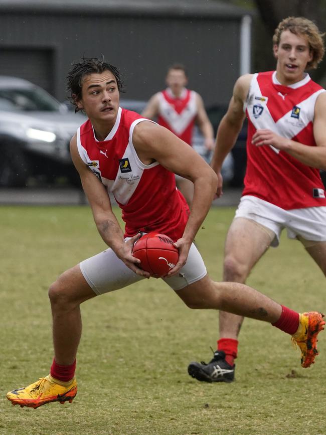 Charlie Robinson-Cay with the ball for Red Hill.