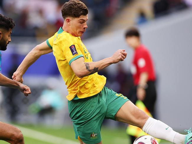 DOHA, QATAR - JANUARY 13: Jordan Bos of Australia is challenged by Nikhil Chandrashekhar of India during the AFC Asian Cup Group B match between Australia and India at Ahmad Bin Ali Stadium on January 13, 2024 in Doha, Qatar. (Photo by Robert Cianflone/Getty Images)