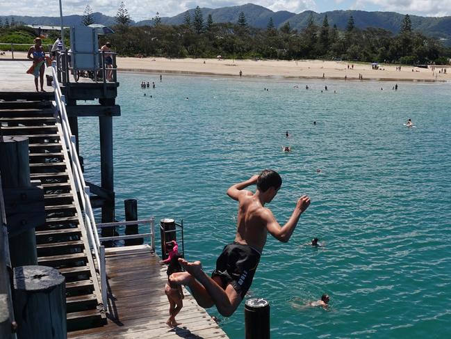 Jayden Coombes from Arrawarra takes the plunge. The weather was on point at the Coffs Harbour Jetty on Boxing Day, 2022. Picture: Chris Knight