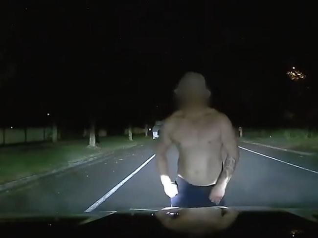 A Queensland woman has shared disturbing footage of a man who jumps in front of her car while driving at night. The driver tries to avoid the man but he blocks the car and punches the windscreen. Picture: Supplied